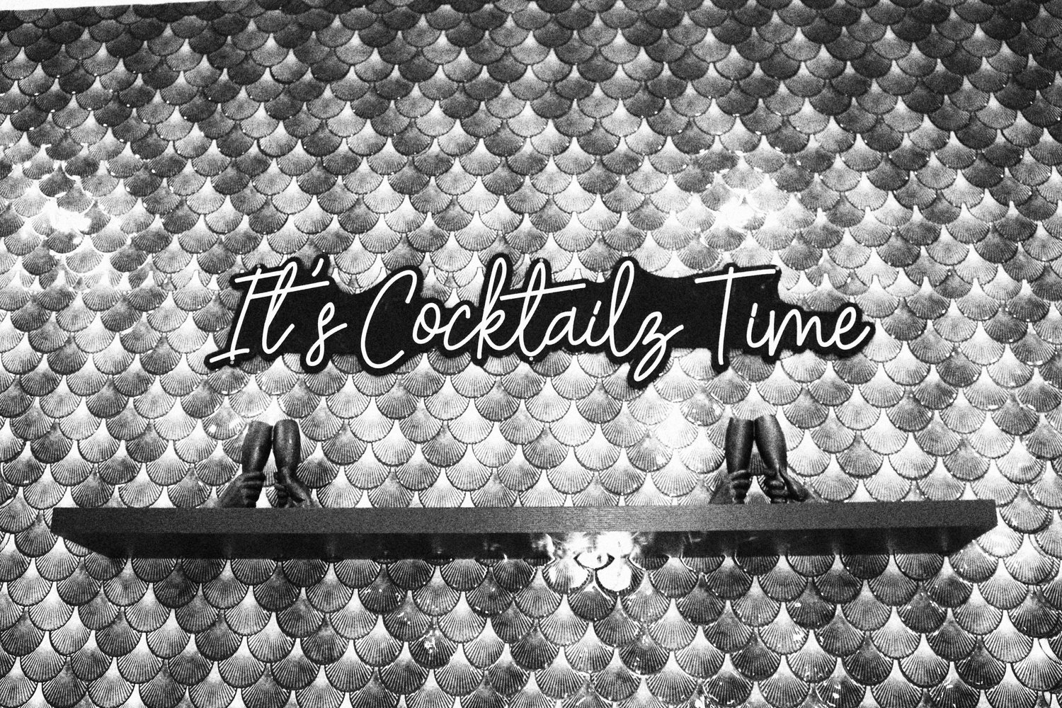"It's Cocktailz Time" sign over a scalloped bar wall, in black and white