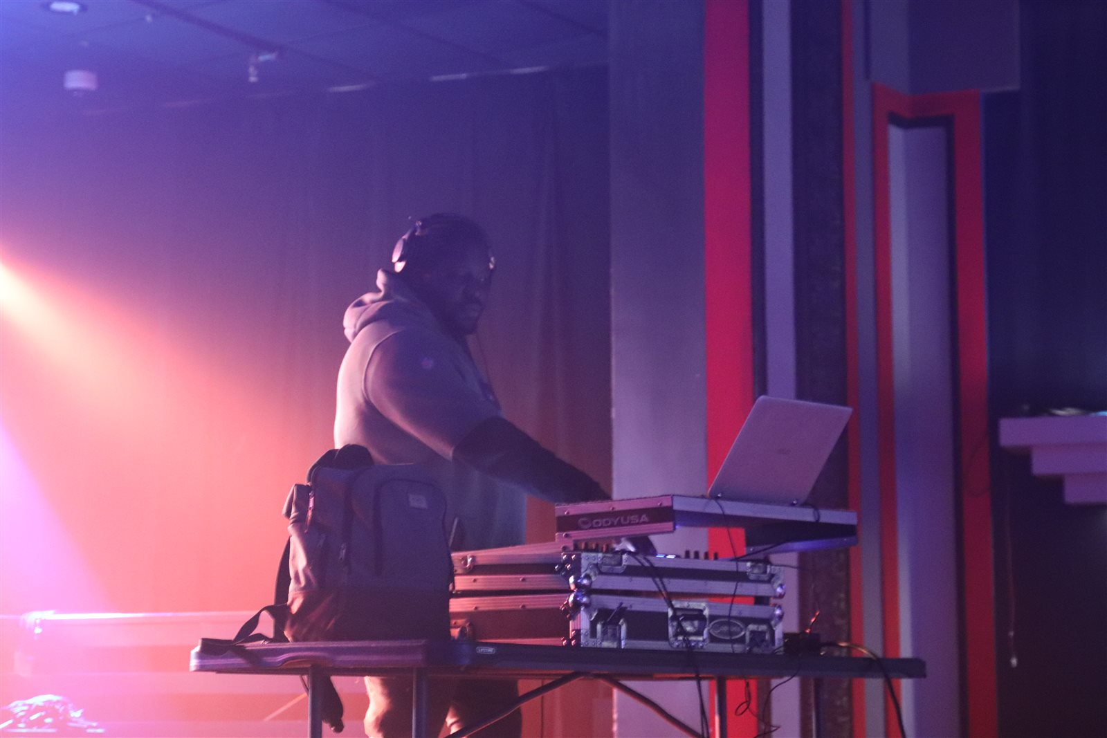 DJ performing under stage lights at a live event