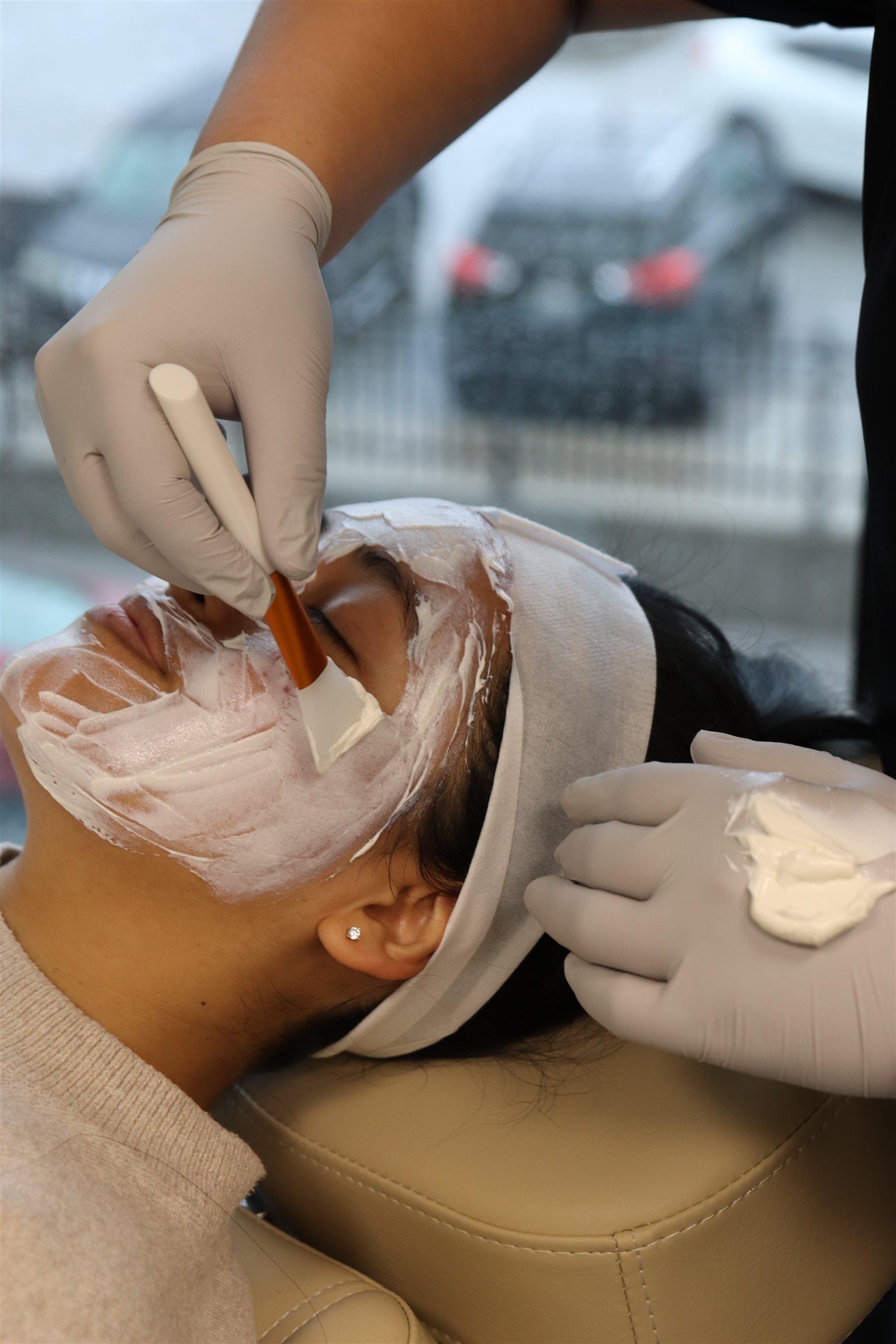 Esthetician applying a facial mask at a med spa