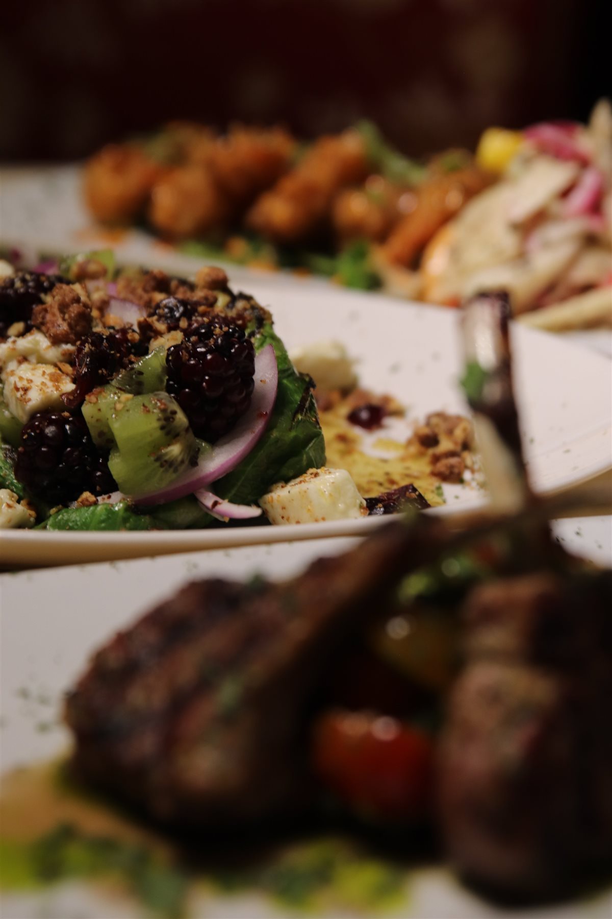 Plated dinner — grilled lamb chops with a blackberry and feta salad